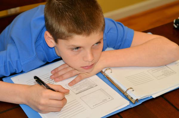 Young boy drifts from his concentration while studying TFGP.